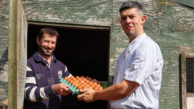 Henry collecting eggs from our producer